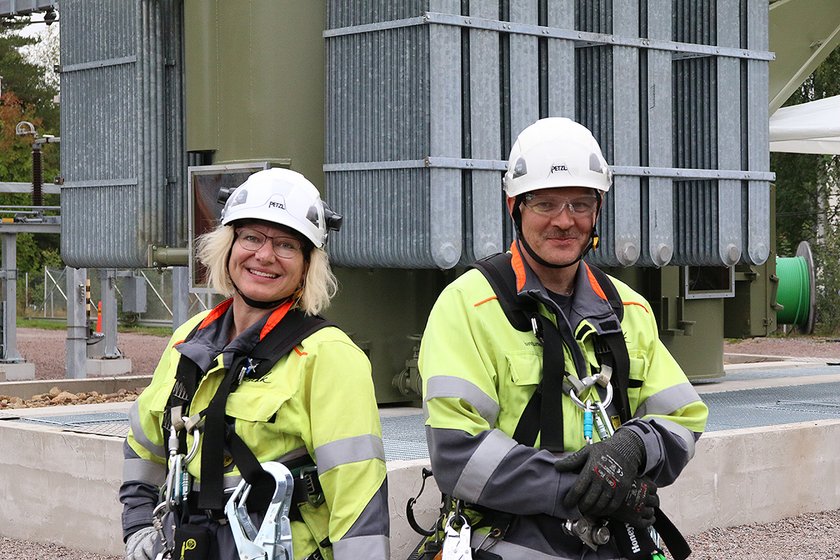 Jaana Harju ja Timo Juntunen seisovat sähkökentän muuntajan edessä.