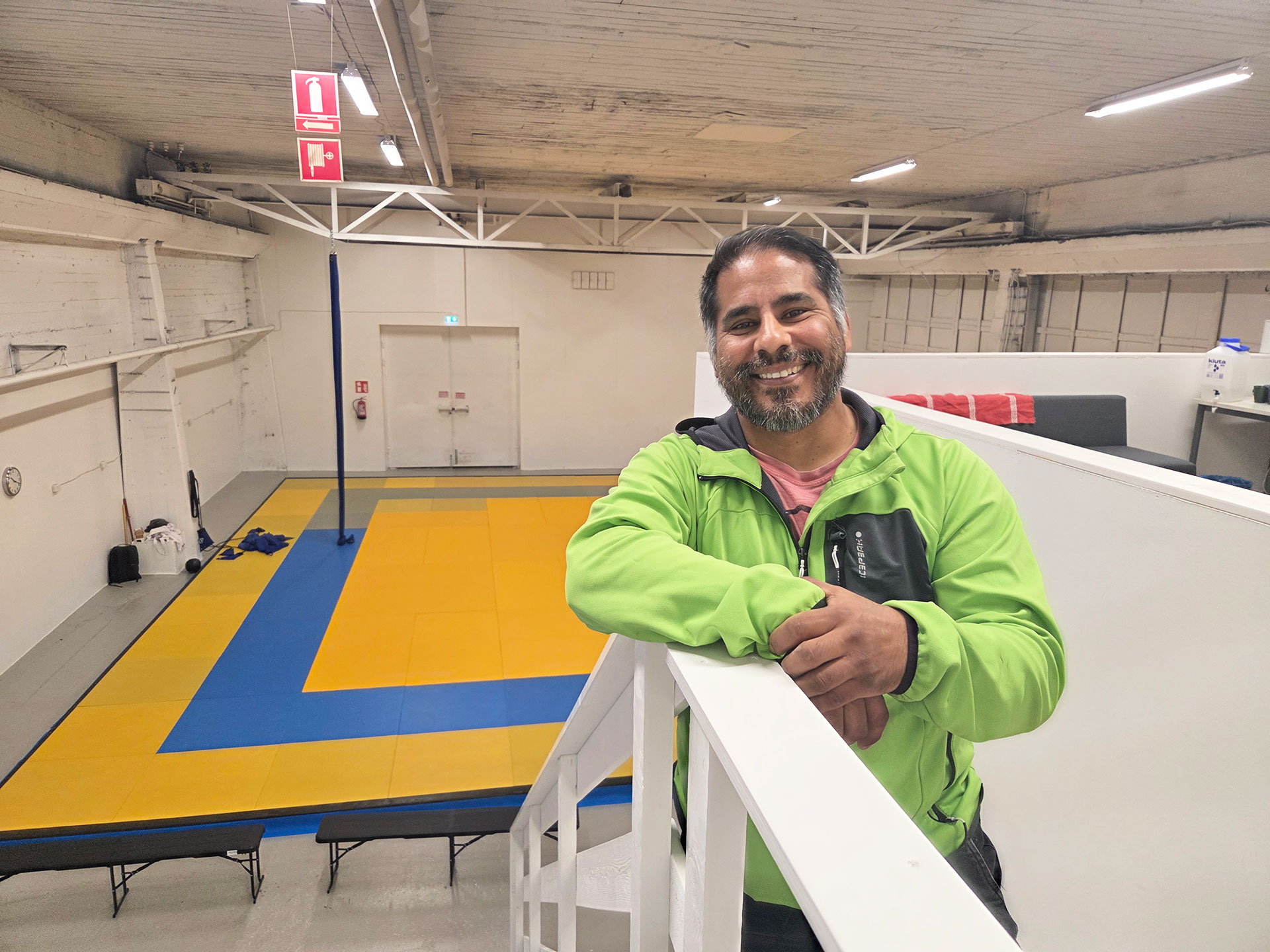Alvaro nojaa porraskaiteeseen, taustalla näkyy keltainen tatami.